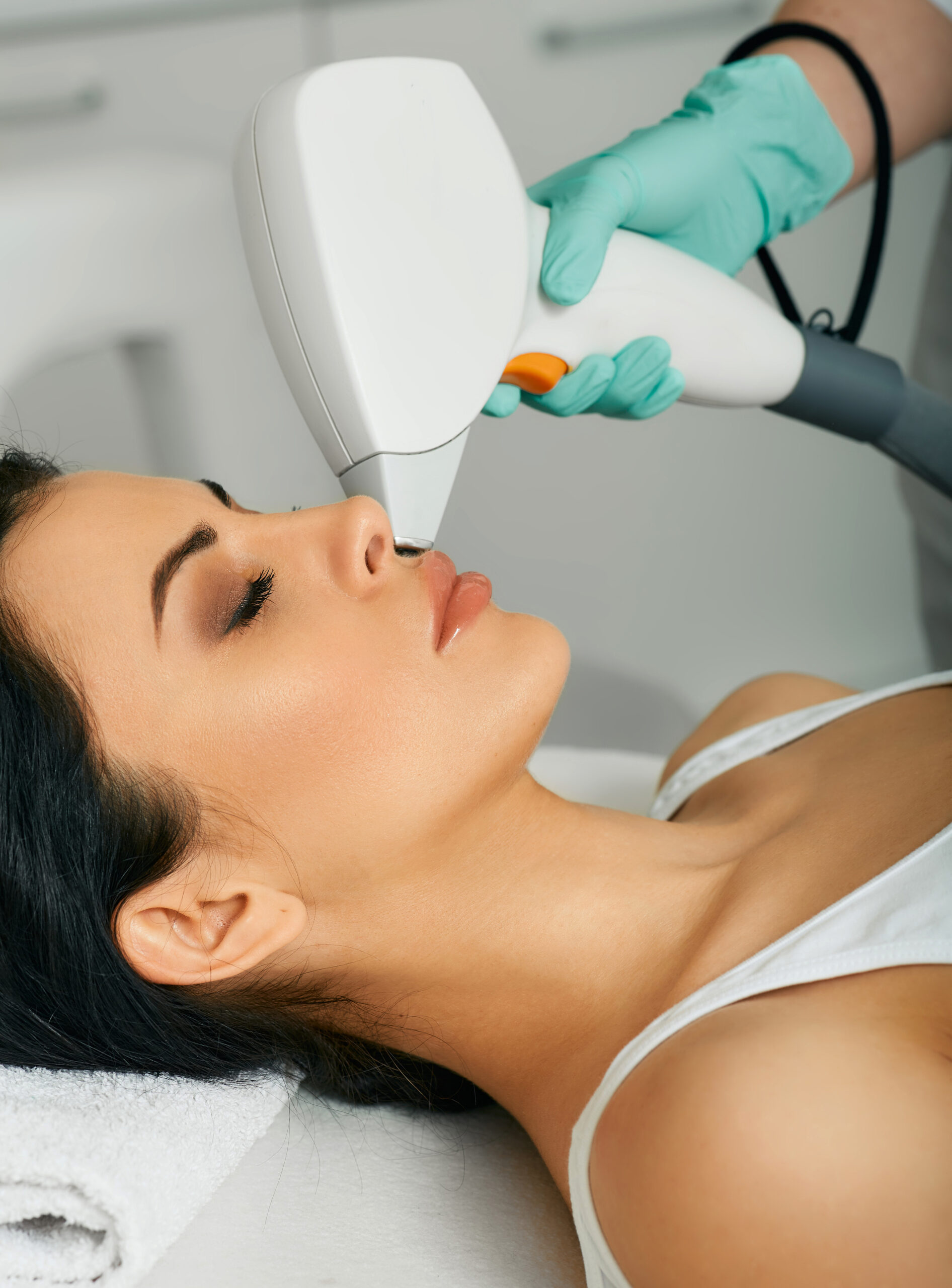 Facial laser hair removal. Beautiful woman during laser hair removal and laser epilation to lips area on her face